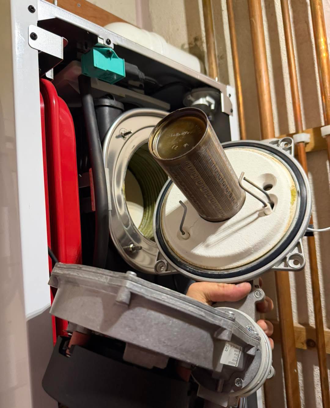 Burner held clear of the heat cell, copper risers behind.