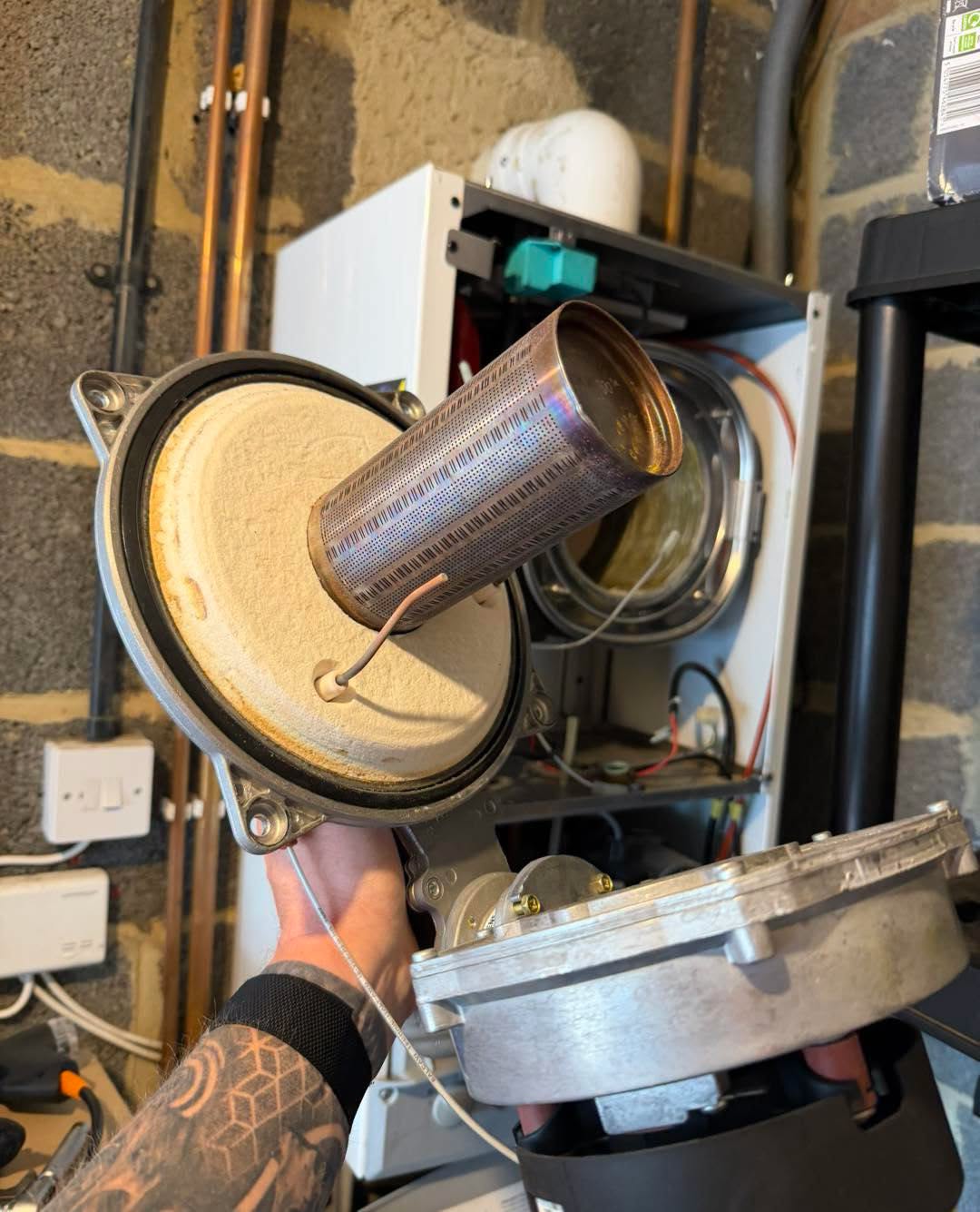 Burner in front of an open boiler in a utility room.