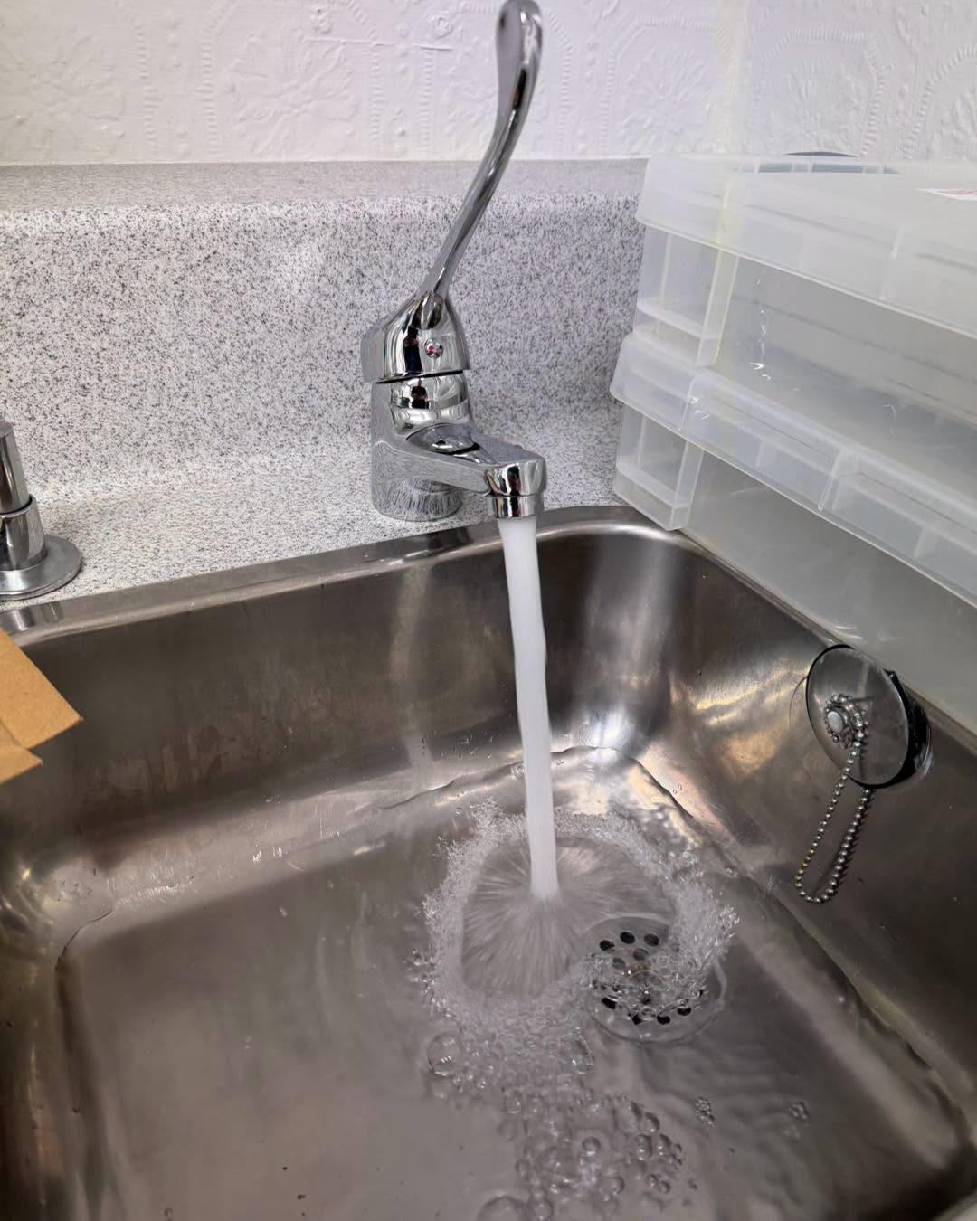 Second lever tap on a worktop sink.