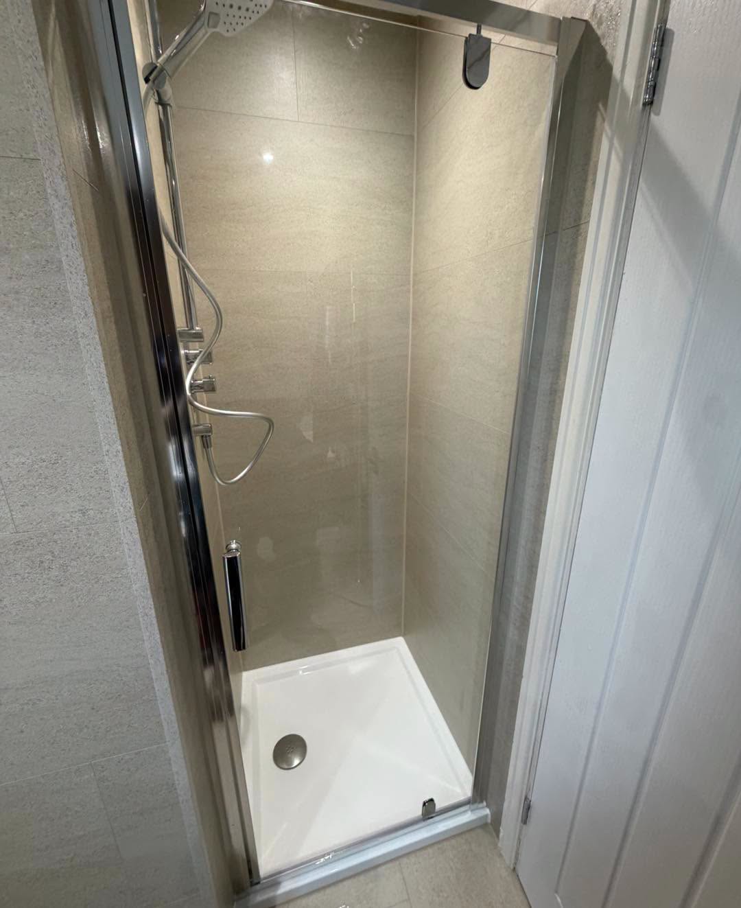 Shower tray with a chrome valve and hose